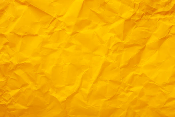 istock Yellow crumpled paper texture. Copy space text 1218612371
