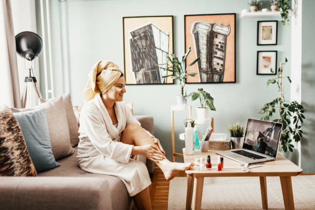 istock Woman with beauty face mask using laptop for video call during coronavirus lockdown 1218612511