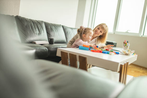 istock Mother and daughter playing with toy bricks 1218612518