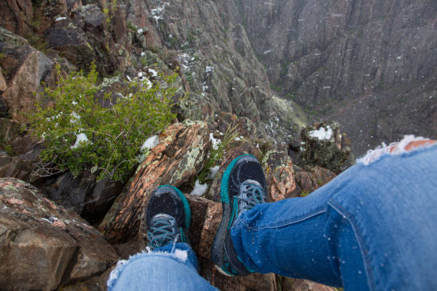 Shoes overlooking the depths of the canyon