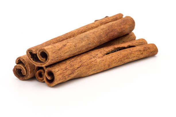 Three cinnamon sticks on a white stock photo