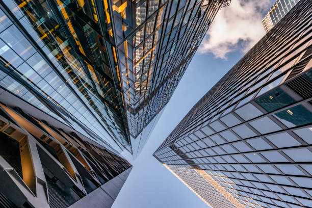 istock Looking up a reflections on glass covered corporate building 1218614230