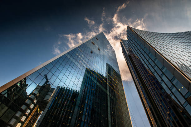 istock Looking up a reflections on glass covered corporate building 1218614797