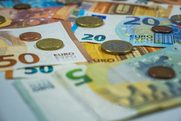 euro money, euro cash background with coins, money banknotes - euro symbol european union currency coin european union coin photos et images de collection