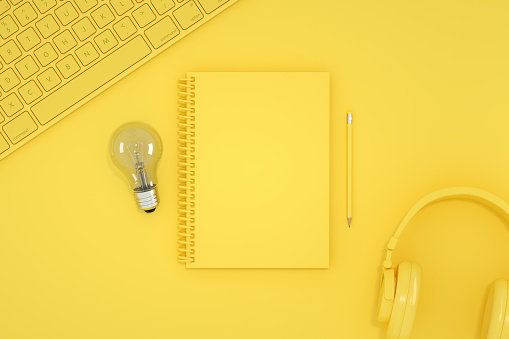 3d rendering of empty notebook with light bulb. Office desktop, Workplace, Home Office. New idea, brainstorming concept. Top view. Yellow background.