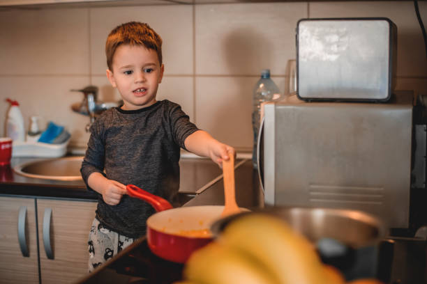 istock Boy helping his mom in the kitchen 1218616758