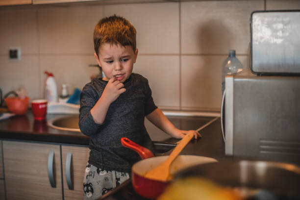 istock Boy helping his mom in the kitchen 1218617035