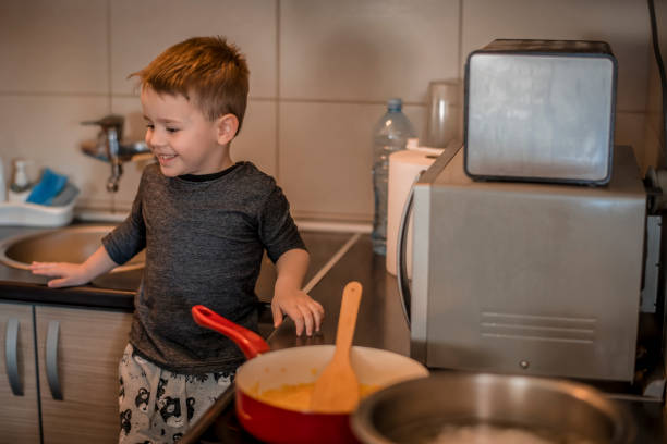 istock Boy helping his mom in the kitchen 1218617806