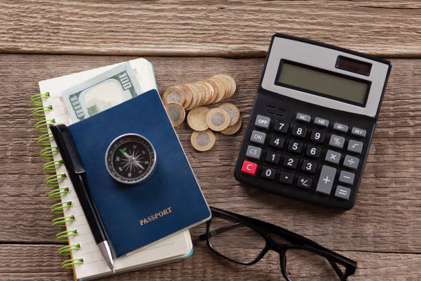 istock compass on passport and coins 1218618299