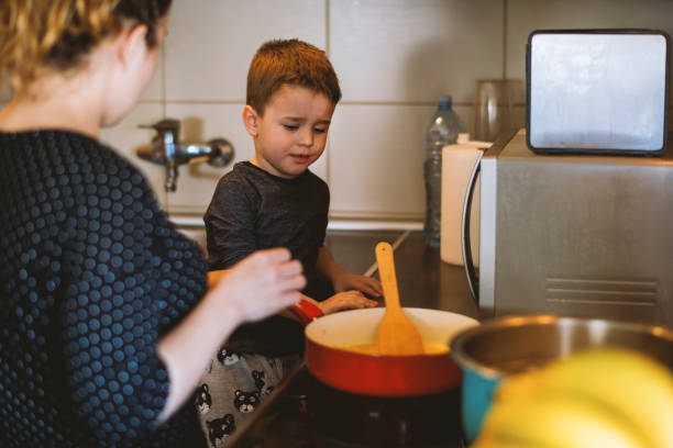 istock Boy helping his mom in the kitchen 1218619141