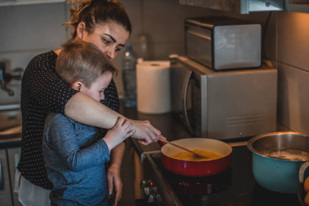 istock Boy helping his mom in the kitchen 1218619634