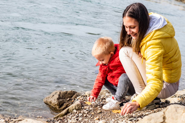 istock Mother and son at the riverbank 1218620380