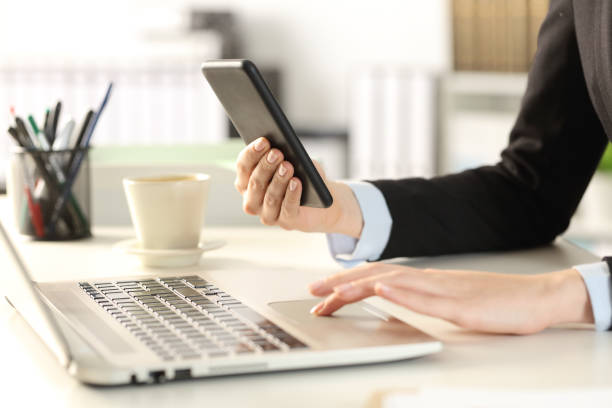 istock Business woman hands using multiples devices at the office 1218620823