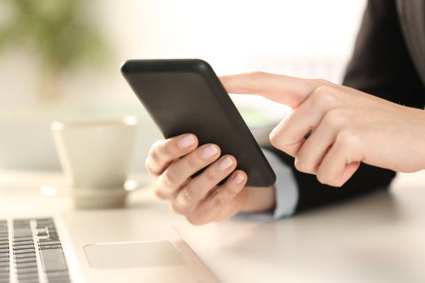 istock Executive woman hands checking phone at office 1218621080