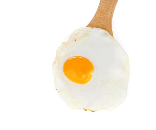 istock Fried egg on a wooden spatula. 1218621098
