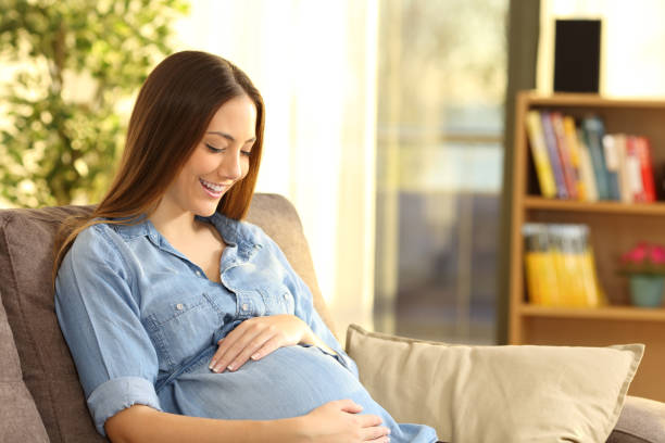 istock Pregnant woman expecting looking at belly 1218621955