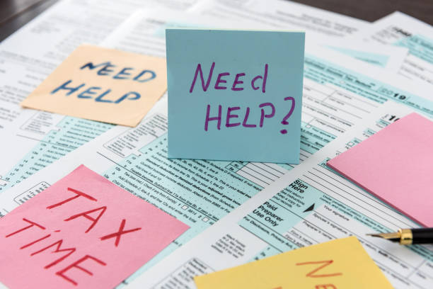 istock Text need help or tax time on sticker lying different tax form. 1218622433