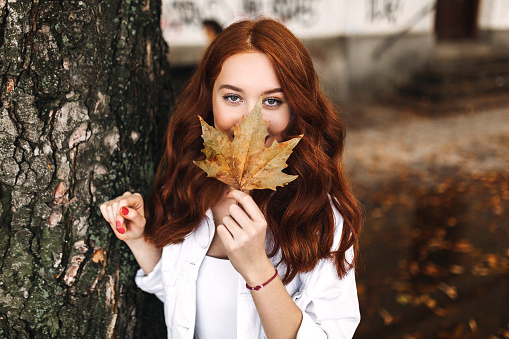 Beautiful woman cover her face with leaf