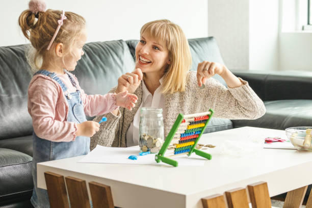 istock Daughter and her mother saving money in a jar 1218623948