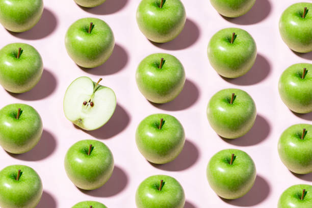 Green Apple Pattern Green apples in a row on pink background green apple slice overhead stock pictures, royalty-free photos & images