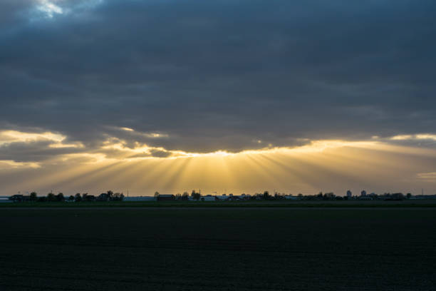 istock Beams of light coming from the sun behind the clouds 1218629536