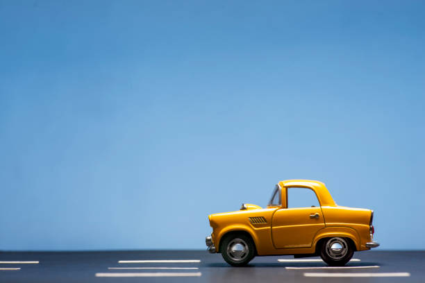 istock Yellow toy car on a blue background. 1218630198