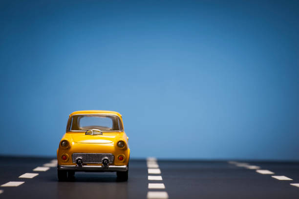 istock Yellow toy car on a blue background. 1218630203
