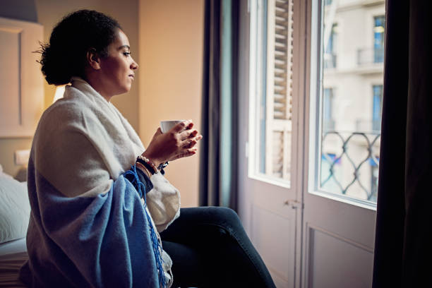 istock Depressed young woman standing sad in home 1218630714
