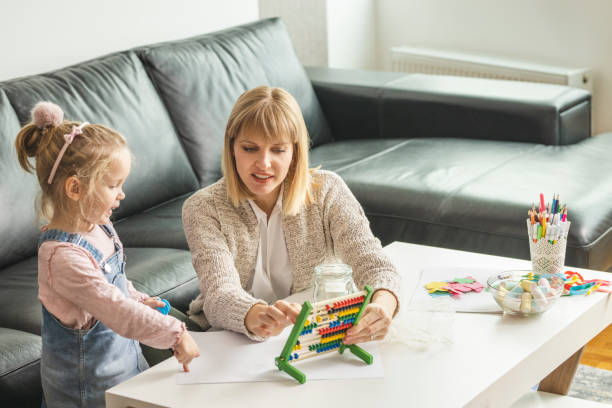 istock Daughter and her mother saving money in a jar 1218630832