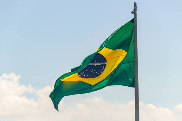 istock Brazilian flag outdoors with blue background in Rio de Janeiro 1218631630