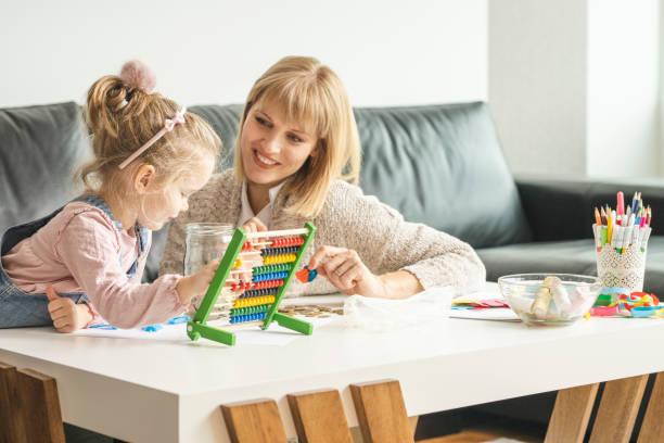 istock Daughter and her mother saving money in a jar 1218631731