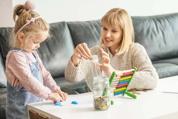 istock Daughter and her mother saving money in a jar 1218632242