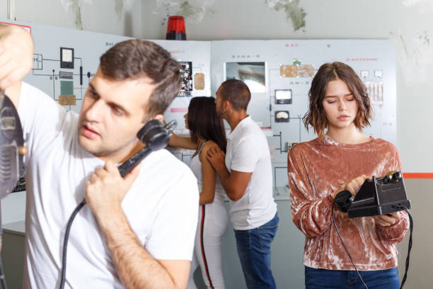 istock Young people with old telephone in lost room-bunker 1218634046