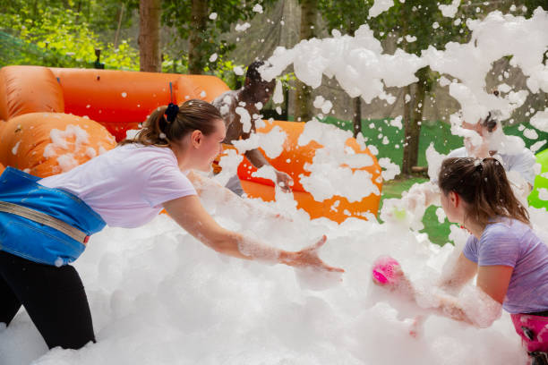 istock Adults collecting balls in inflatable pool with foam 1218635177