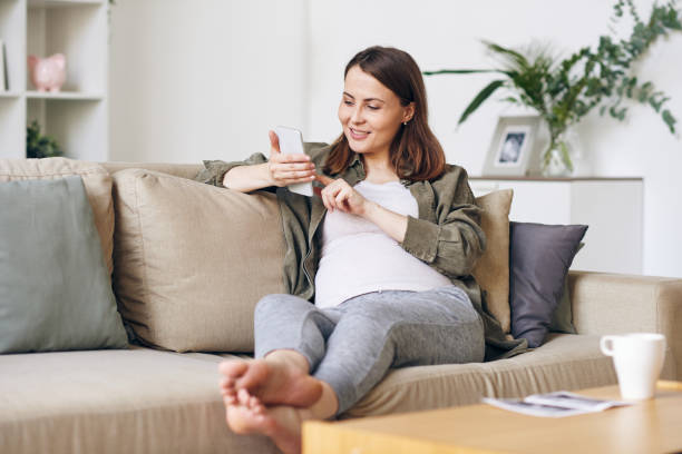 istock Reading internet articles about baby-raising 1218635223