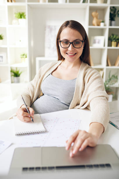 istock Pretty pregnant lady working with laptop 1218637209