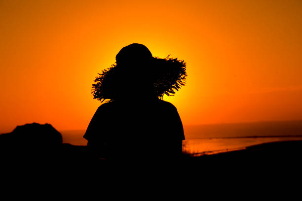 istock tourist woman hat silhouette 1218638930