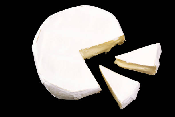 istock Camembert with slices isolated on black background. Soft cheese covered with edible white mold view from above. top view 1218639870