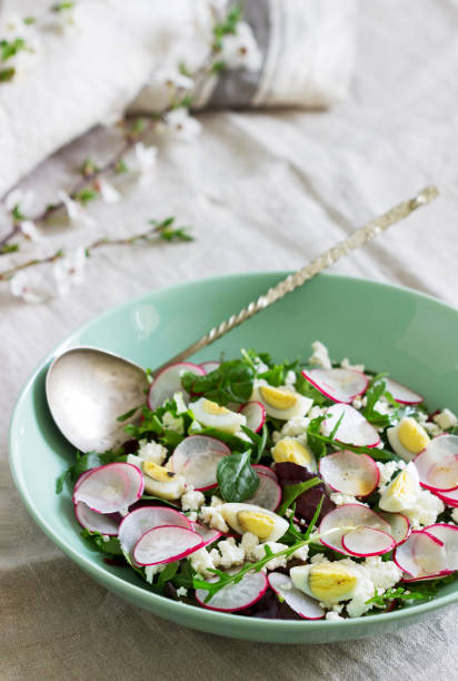 istock Vegetarian salad with herbs, radish, eggs and cottage cheese on a light background. 1218639883