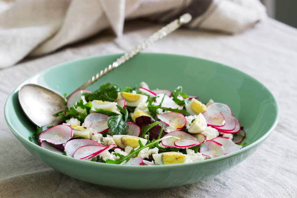 istock Vegetarian salad with herbs, radish, eggs and cottage cheese on a light background. 1218639890