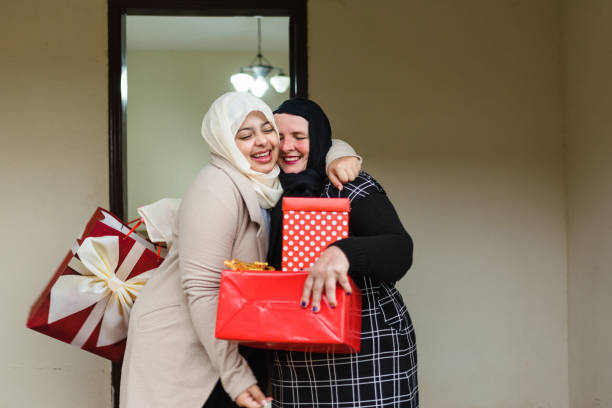 Happy Muslim women with gift boxes