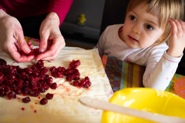 istock Little girl and sour cherry pie 1218641565