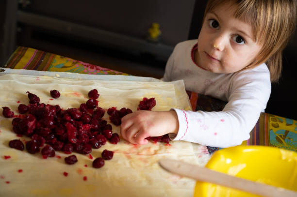 istock Little girl and sour cherry pie 1218641662