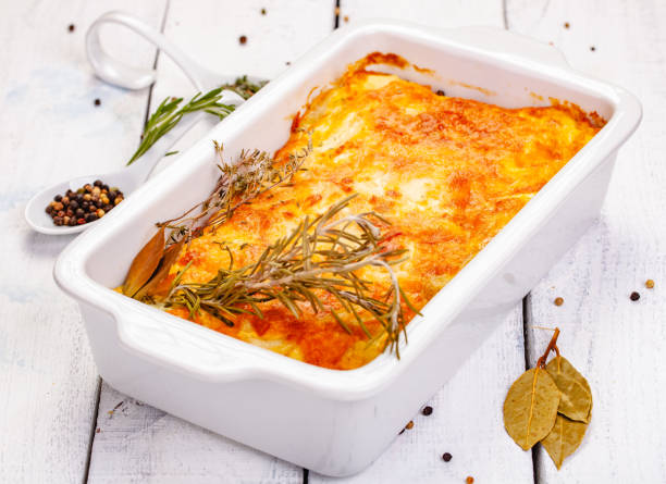 istock Potato gratin in white casserole dish on wooden rustic table. Close up 1218641946