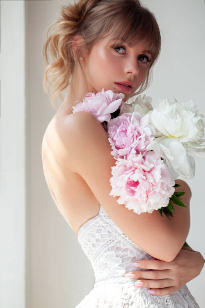 istock Beautiful bride with bouquet of fresh peonies 1218643208