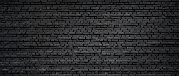 istock Texture of a black brick wall 1218645304