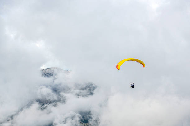 istock Paragliding in cloudy weather. 1218647656