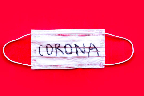 istock Medical mask on bright red background. Coronavirus concept 1218648822