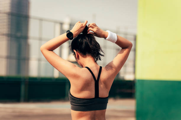 istock Runner Tying Hair into a Ponytail: Back View 1218648970