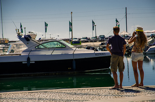 Couple waiting for a yacht to arrive in Faro, Portugal